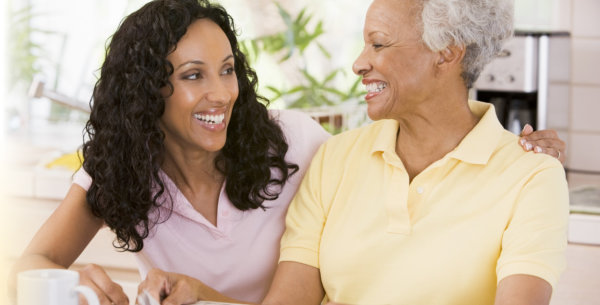 Elderly woman with her caregiver smiling